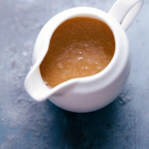 Container filled with creamy buttermilk syrup, with a silky texture, ready to be poured.