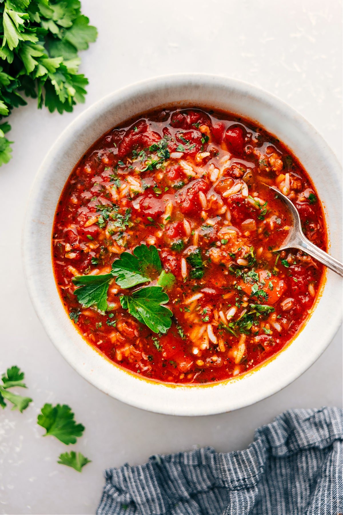 Stuffed Pepper Soup in a bowl, topped with fresh parsley and grated Parmesan.