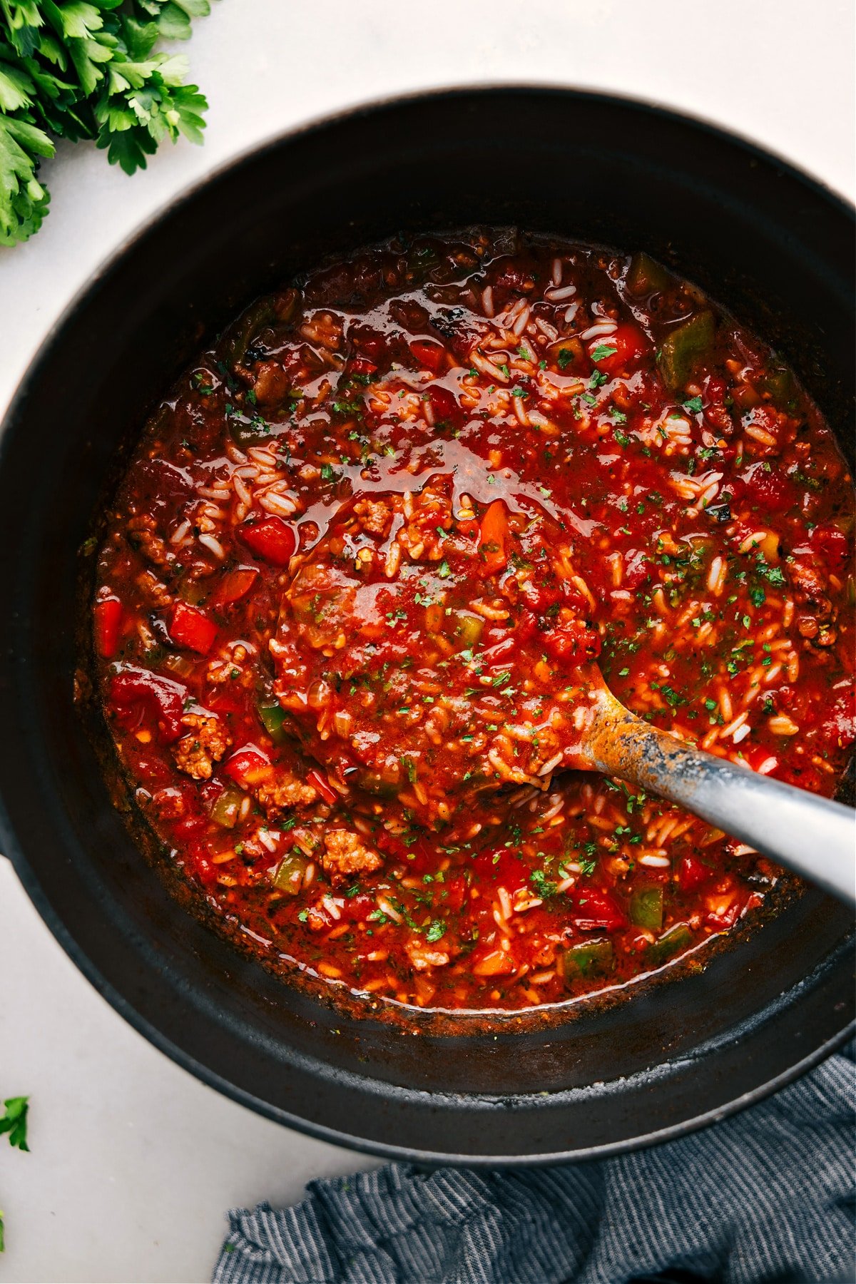 Stuffed Pepper Soup in the pot with a ladle taking a big scoop to serve.