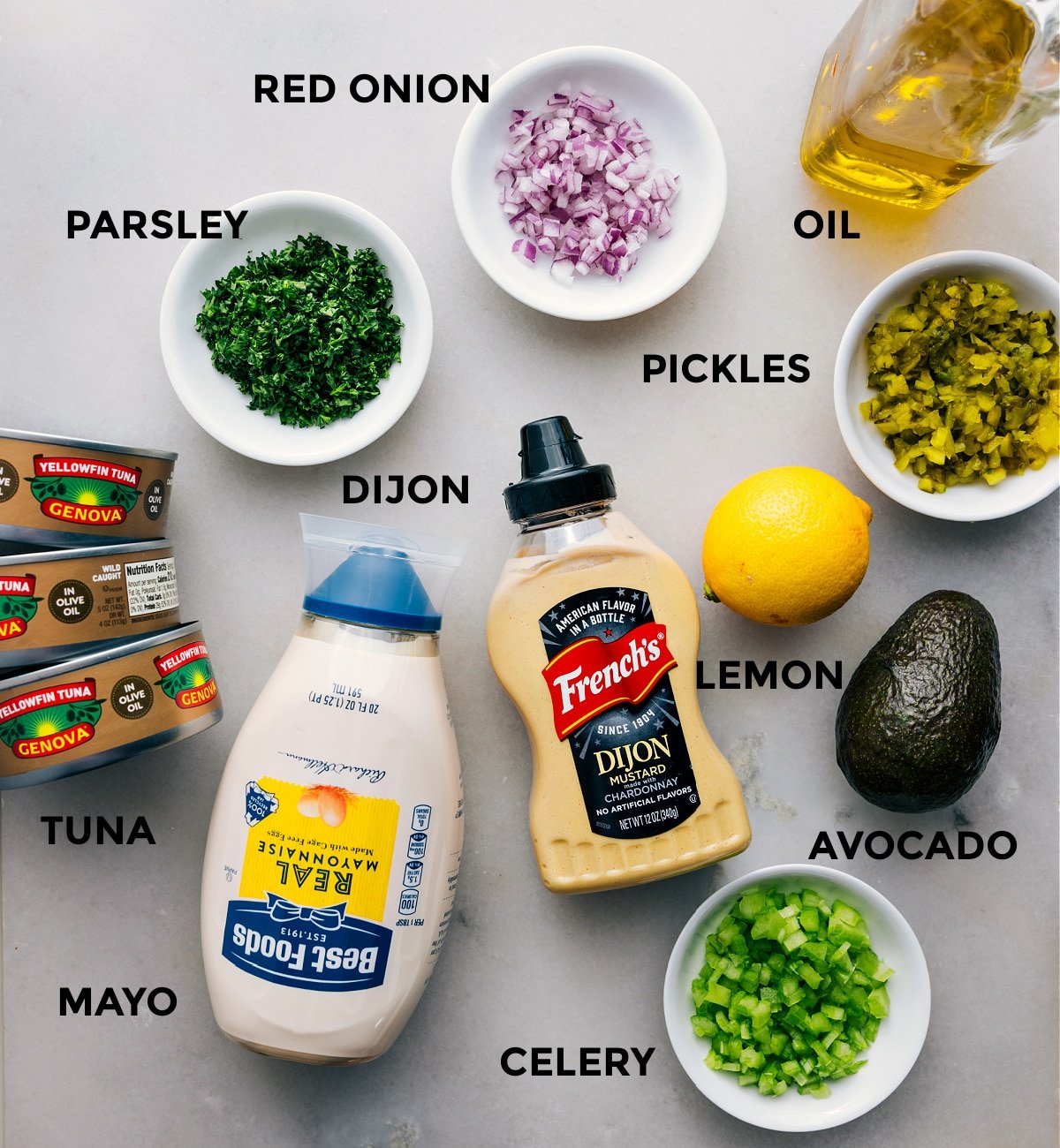 All the ingredients—meat, parsley, red onion, pickles, oil, lemon, avocado, Dijon, mayo, and celery—are prepped for easy assembly.