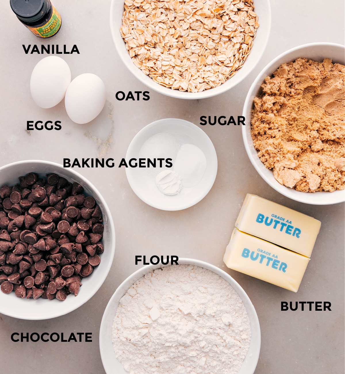 All the ingredients in this recipe—flour, chocolate, butter, sugar, oats, vanilla, eggs, and baking agents—are prepped and ready for easy assembly.