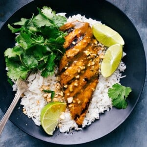 Savory grilled curry chicken atop a bed of fluffy rice, ready to be served.