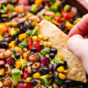 Cowboy Caviar in a bowl with a chip dipping in.