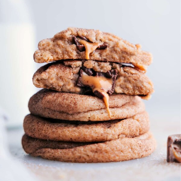 A stack of mouthwatering caramel snickerdoodles with centers oozing with melting caramel and chocolate.