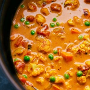 A hearty pot of vegetable curry brimming with colorful vegetables and simmered in a coconut curry broth.