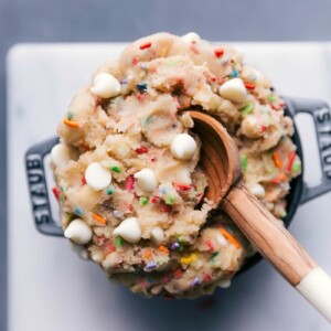 Scrumptious edible cake batter in a bowl, complete with a spoon, ready for indulgence.