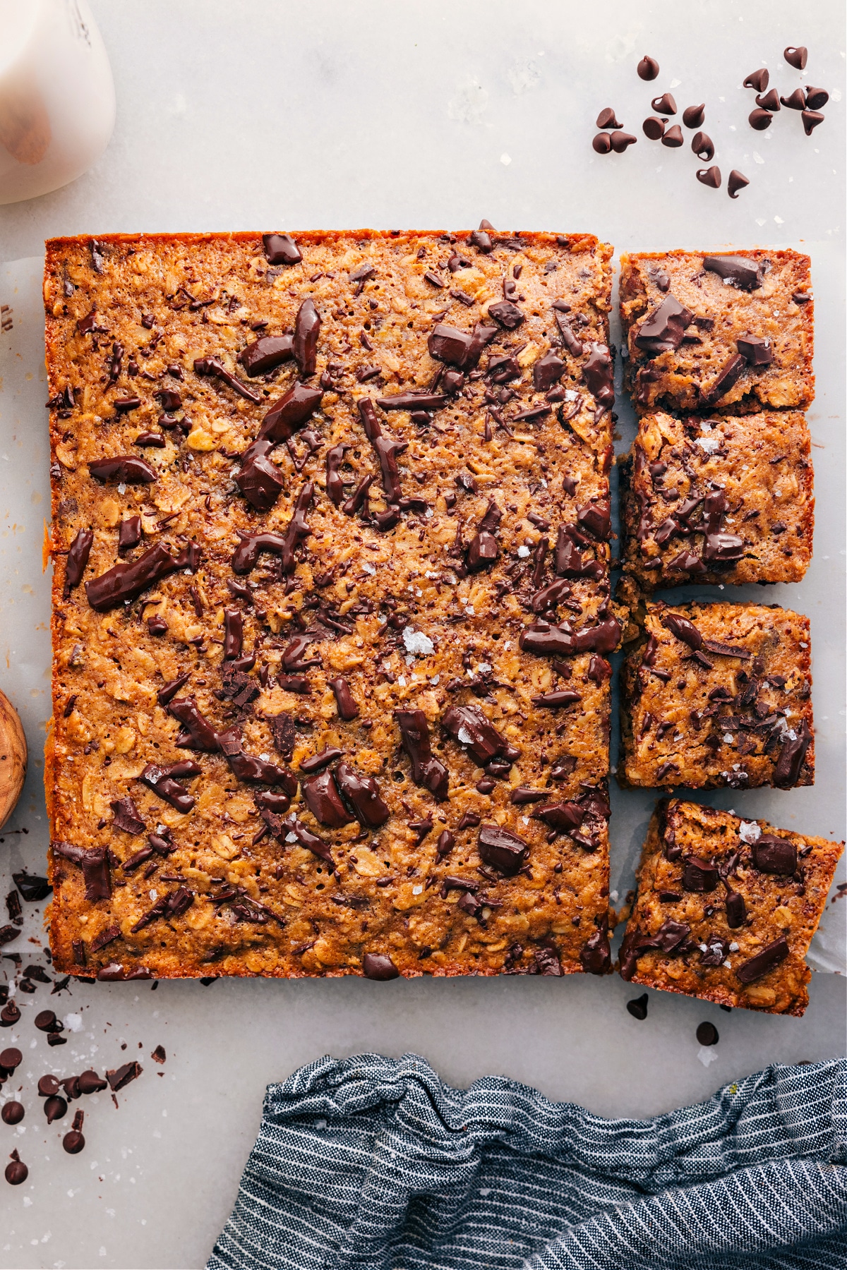 Oatmeal Breakfast Bars with a few squares cut and topped with chocolate, ready to enjoy.