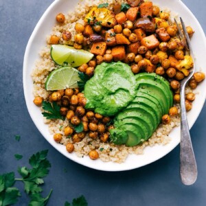 Healthy buddha bowl complete with fresh avocado slices, prepared and ready for a nutritious meal.