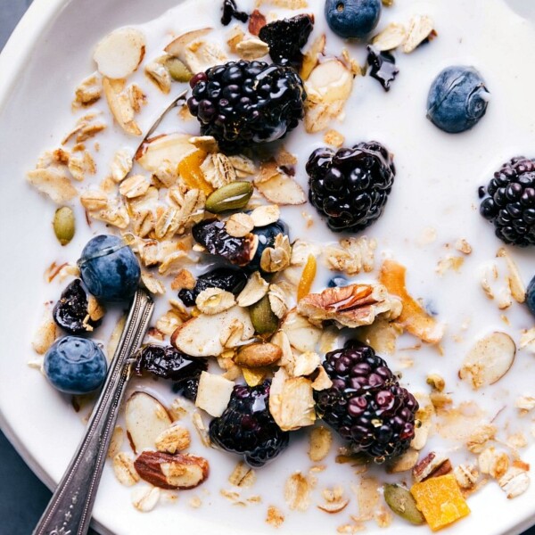 Bowl of muesli with milk and a topping of fresh berries, ready for a healthy breakfast.