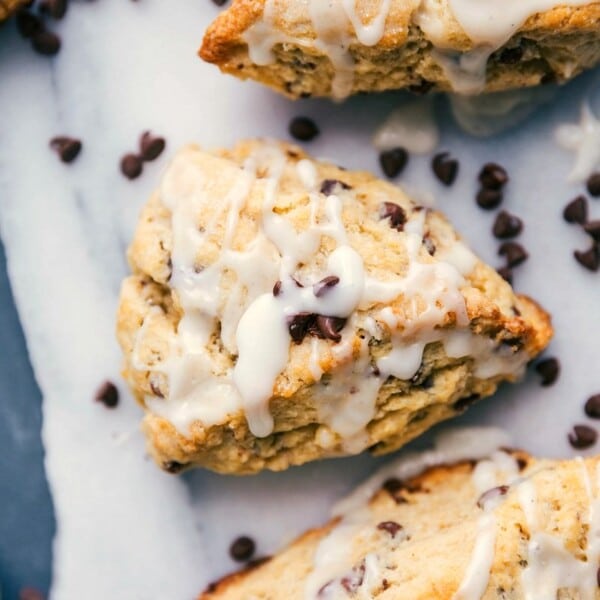 Chocolate chip scones with a luscious glaze and scattered chocolate chips, ready to be devoured.