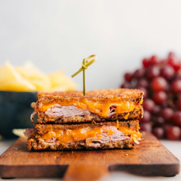 The melty ham and cheese sandwich cut in half showing the delicious insides.