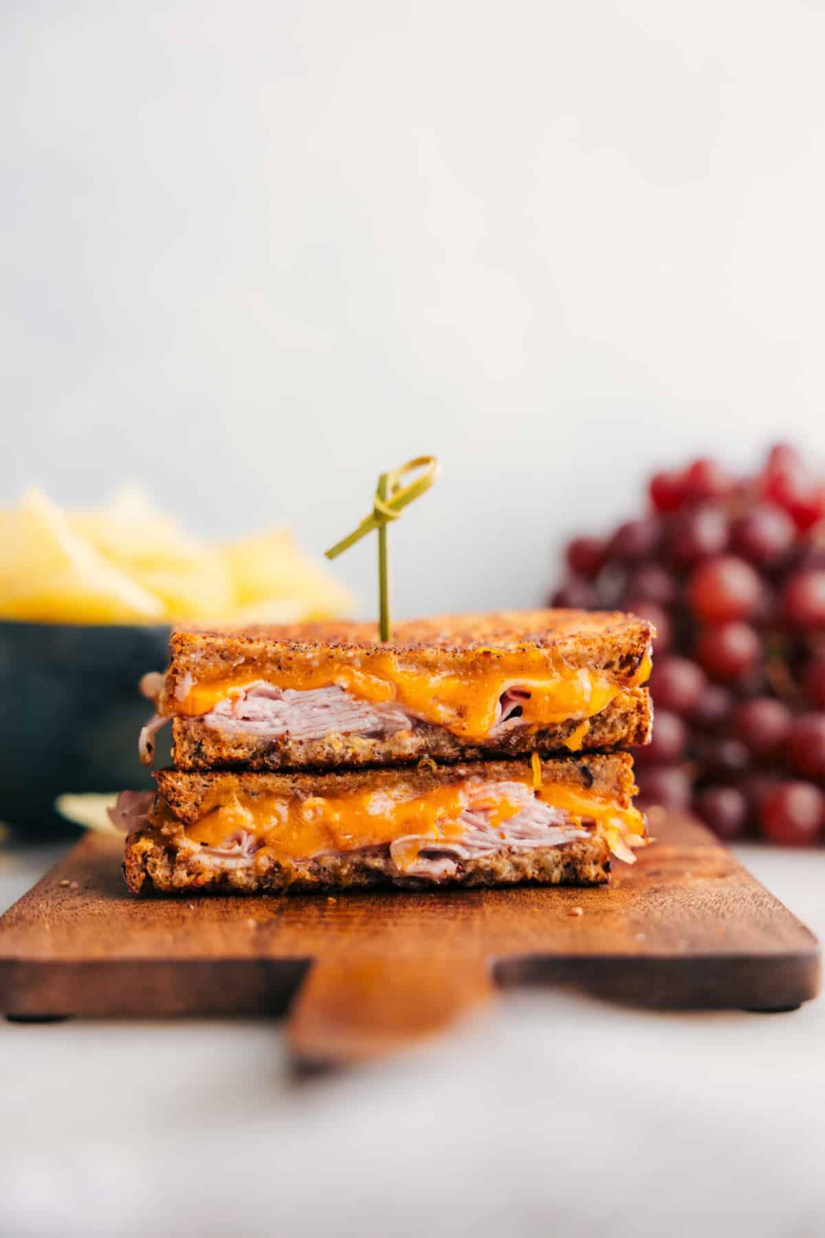 The melty ham and cheese sandwich cut in half showing the delicious insides.