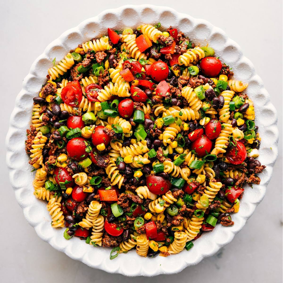 The dish is in a bowl, tossed together and ready for the creamy dressing.