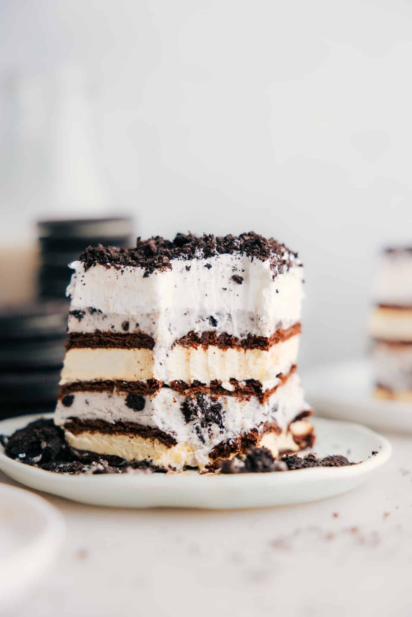 Ice cream sandwich cake with a bite out of it showing all the layers.