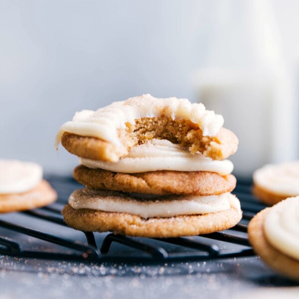 Cinnamon roll cookies stacked neatly, topped with delicious frosting to complement their sweet cinnamon flavor.