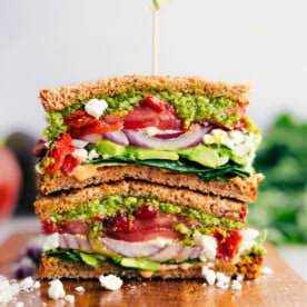 Easy, vegetarian Mediterranean Sandwich—pile veggies, creamy feta cheese, and basil pesto on hearty bread.