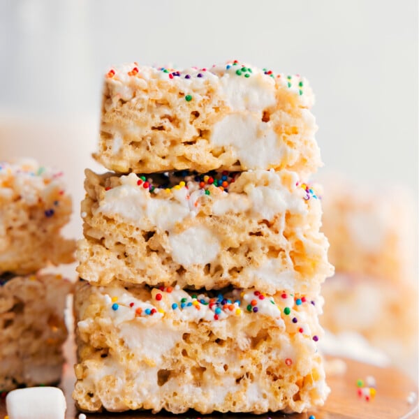 Rice Krispie Treats squares stacked on top of each other showing the gooey and delicious texture.