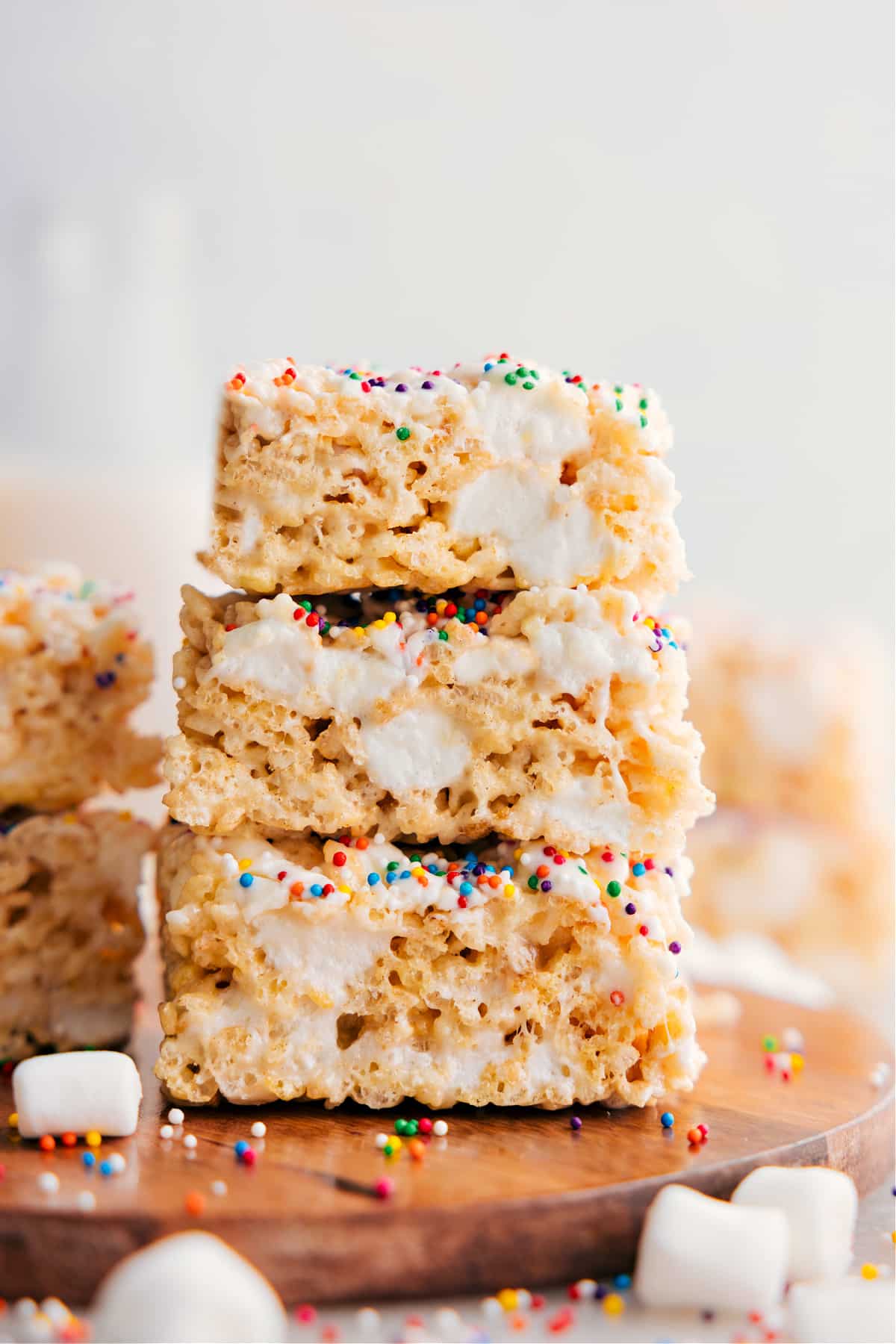 Rice Krispie Treats squares stacked on top of each other showing the gooey and delicious texture.