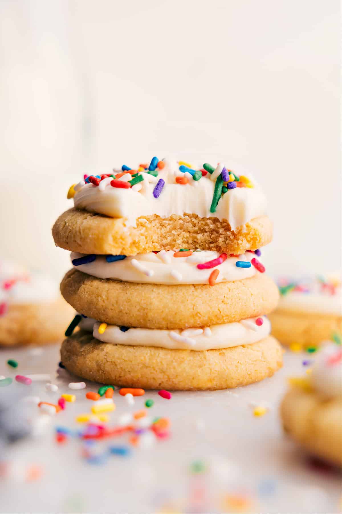 Soft Sugar Cookies stacked, with a bite taken from the top one.