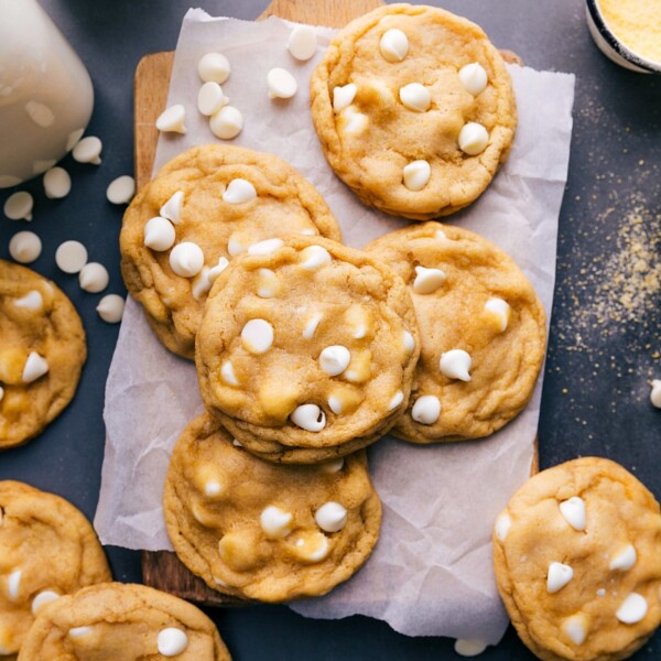 A batch of freshly baked cornmeal cookies, each one topped with white chocolate chips, delicious and flavor-packed.