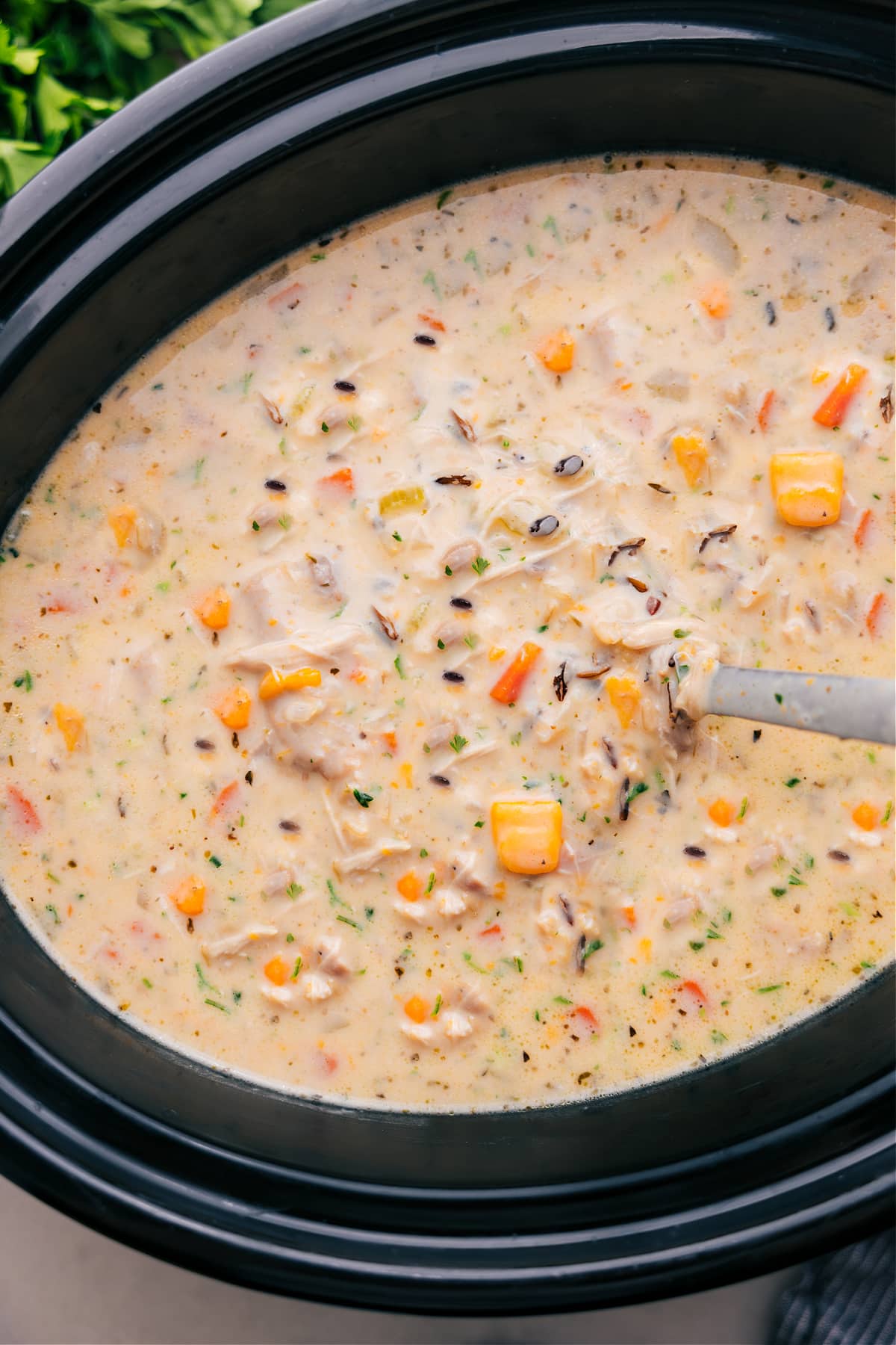 Enjoy the Crockpot Chicken Wild Rice Soup after it finishes cooking in the slow cooker.