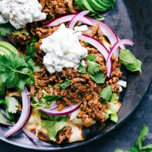 Ground beef naan tacos with all the toppings, a delicious meal with complimentary flavors ready to be enjoyed.