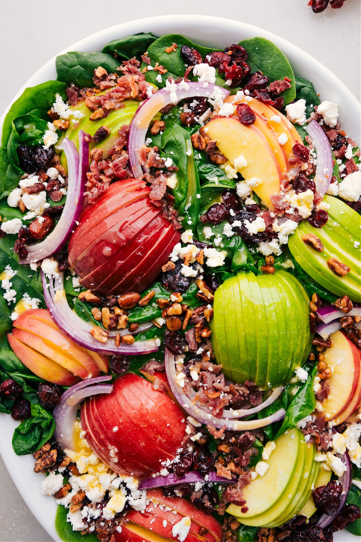 Spinach Salad dressed and ready to be tossed together.