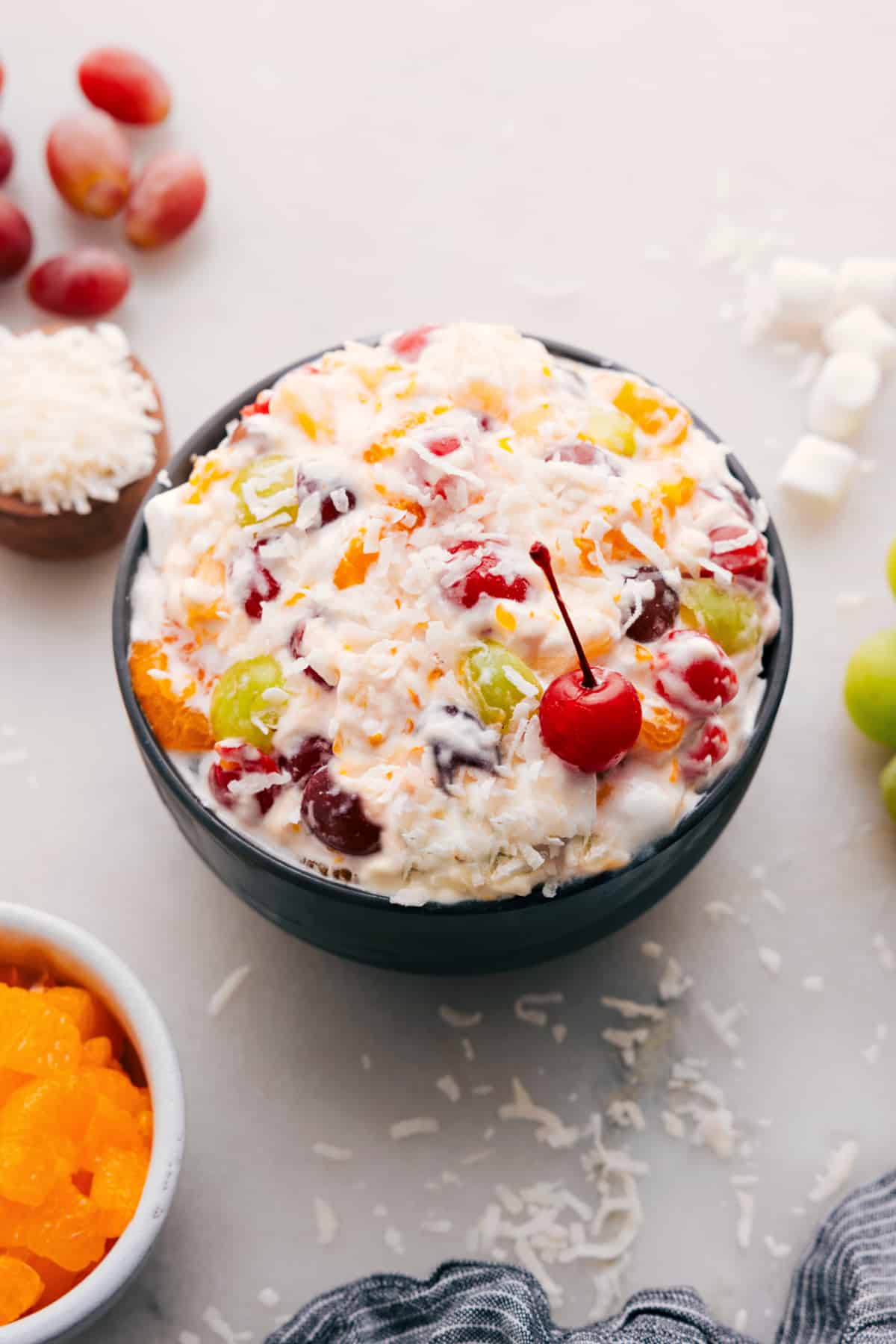 Ambrosia Salad in a bowl with a cherry on top.