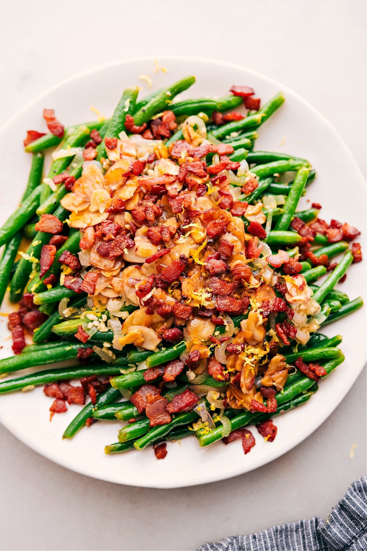 Green Beans with Bacon, topped with fresh lemon juice and zest, make a delicious side.