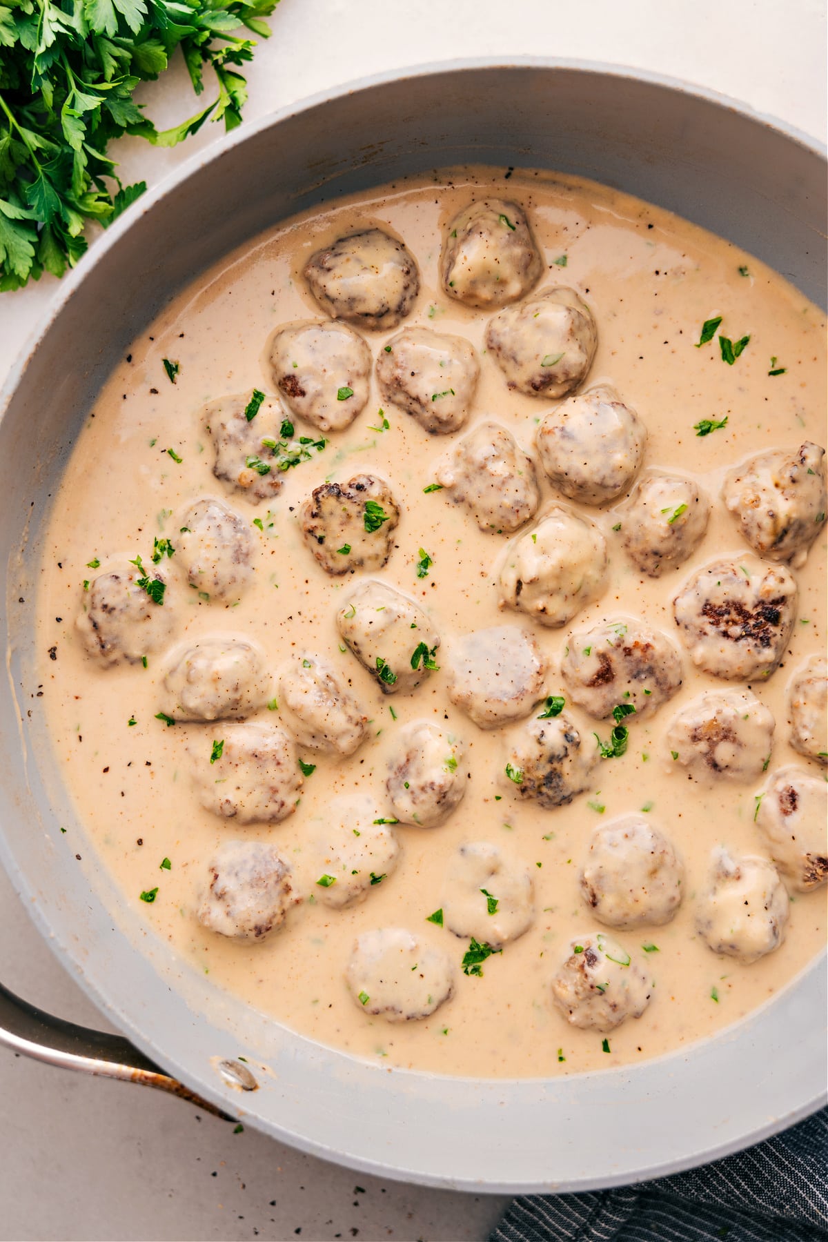 Swedish Meatballs simmering in cream sauce.