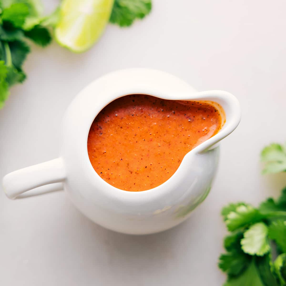 Chipotle lime dressing in a container to top the salad.