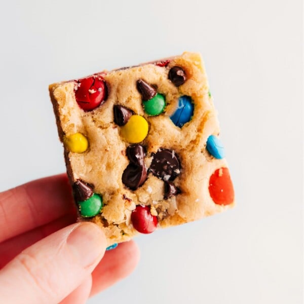 M&M Cookie Bars being held up.