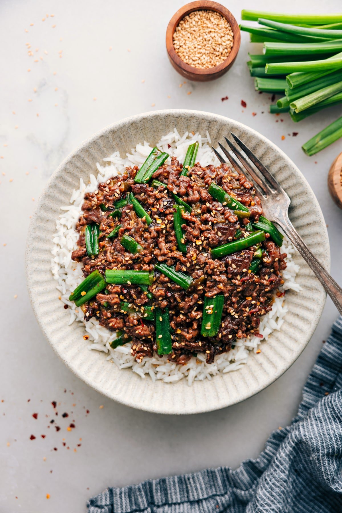 Mongolian Ground Beef served over rice, topped with fresh green onions.