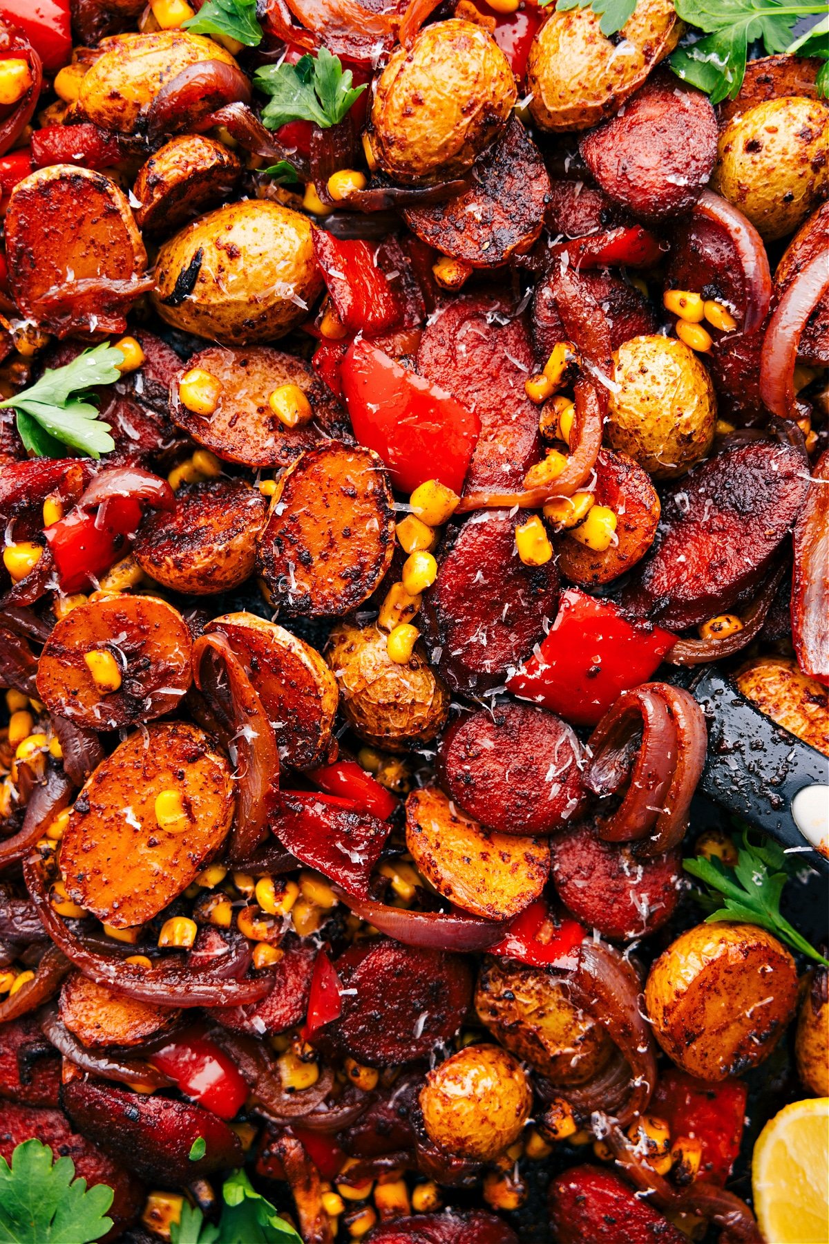 One skillet Sausage, Potatoes, & Corn bakes in the oven and gets topped with parmesan.