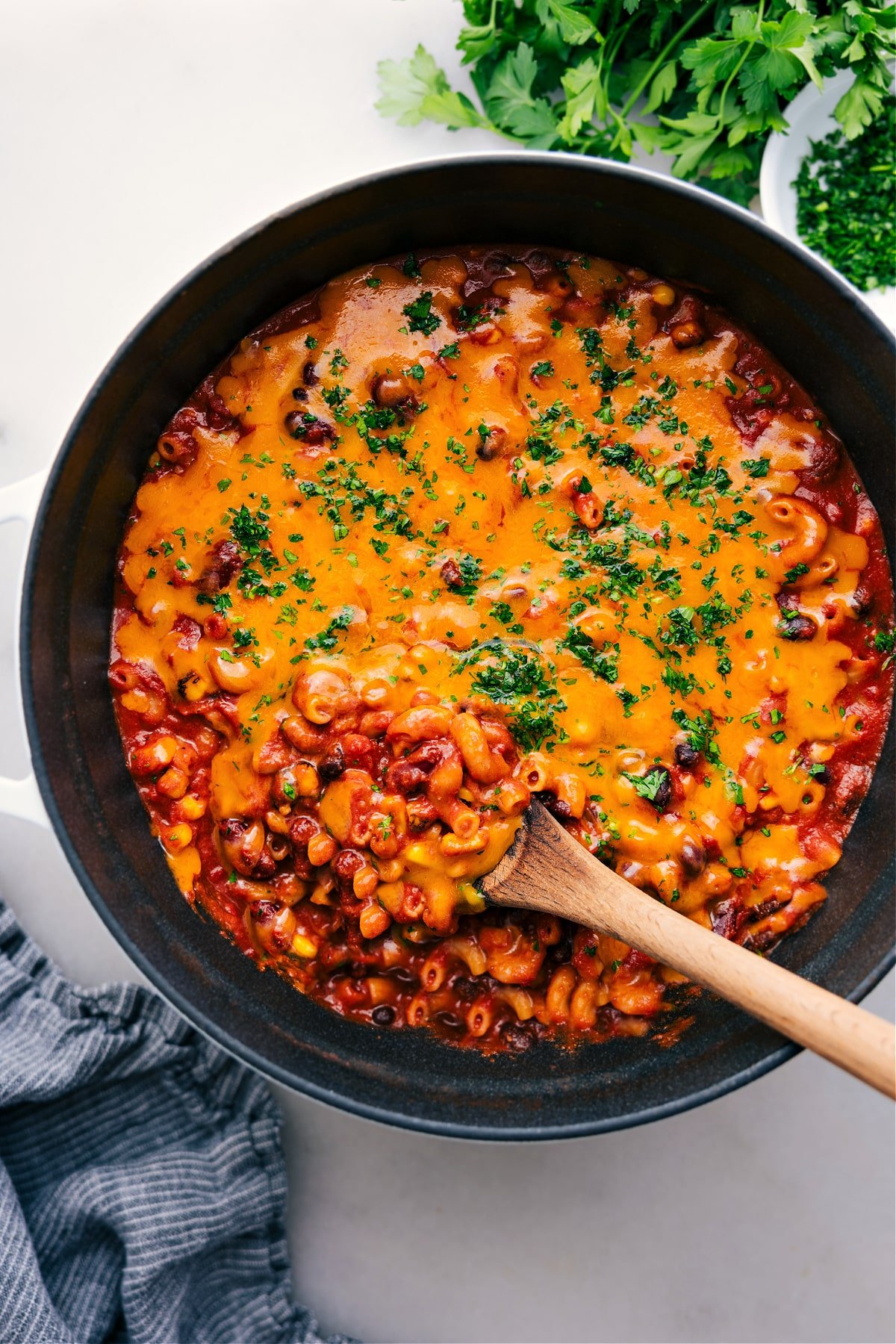 One pot vegetarian chili mac recipe in the pot with a cheesy spoonful coming up.