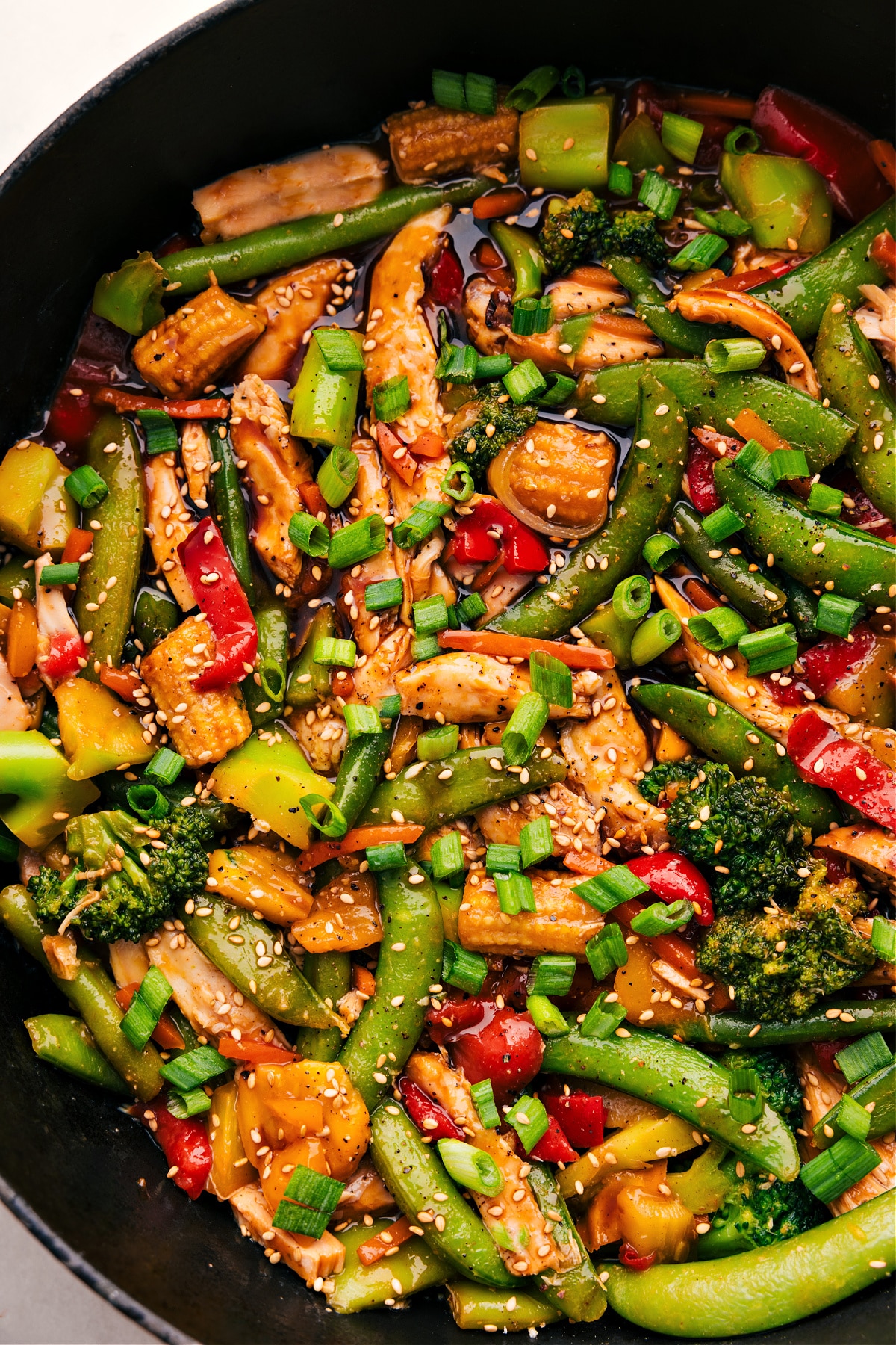 The rotisserie chicken stir fry with its delicious sauce sits in the skillet, ready to serve and enjoy.