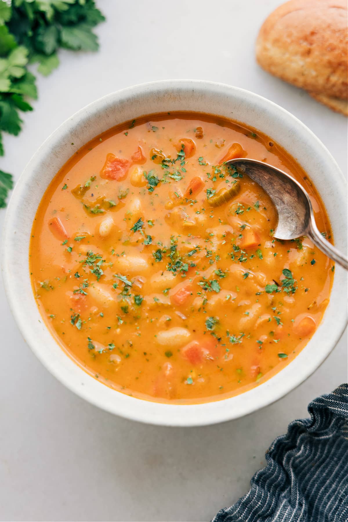 Serve the white bean soup in a bowl and top with fresh herbs.