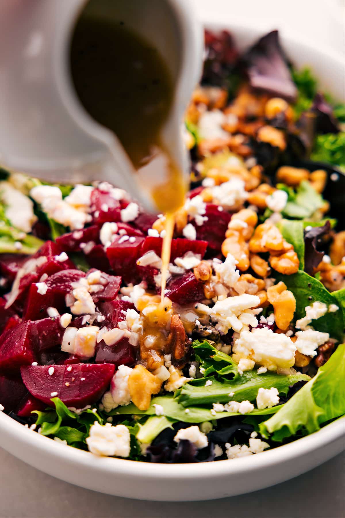 Dress the beet goat cheese walnut salad with the delicious dressing.