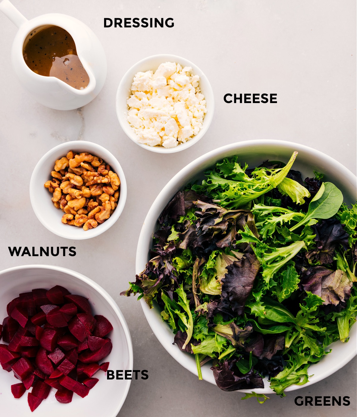 All the ingredients for this beet goat cheese walnut salad—greens, cheese, walnuts, and beets—are prepped and ready for easy assembly.