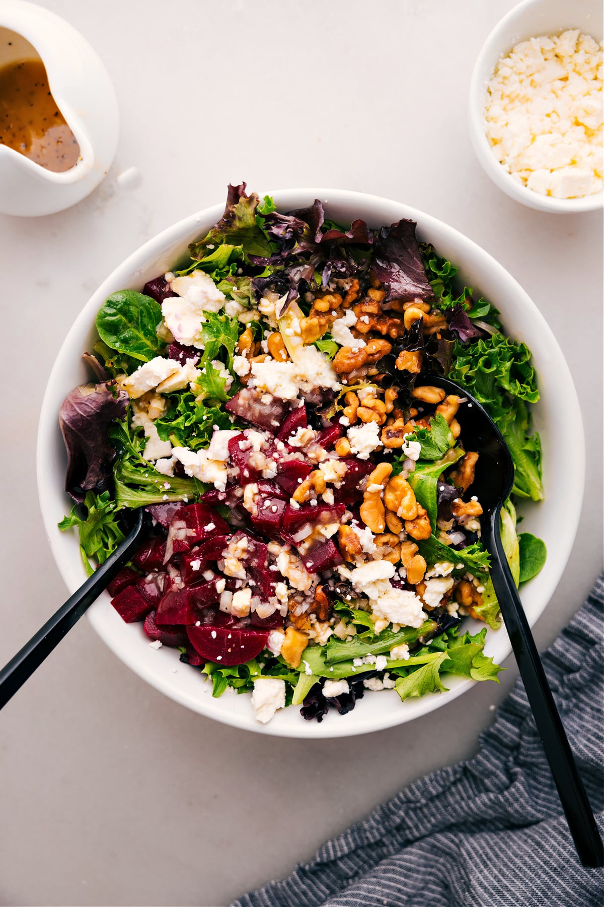 Enjoy a bowl of Beet Goat Cheese Walnut Salad topped with a delicious dressing.