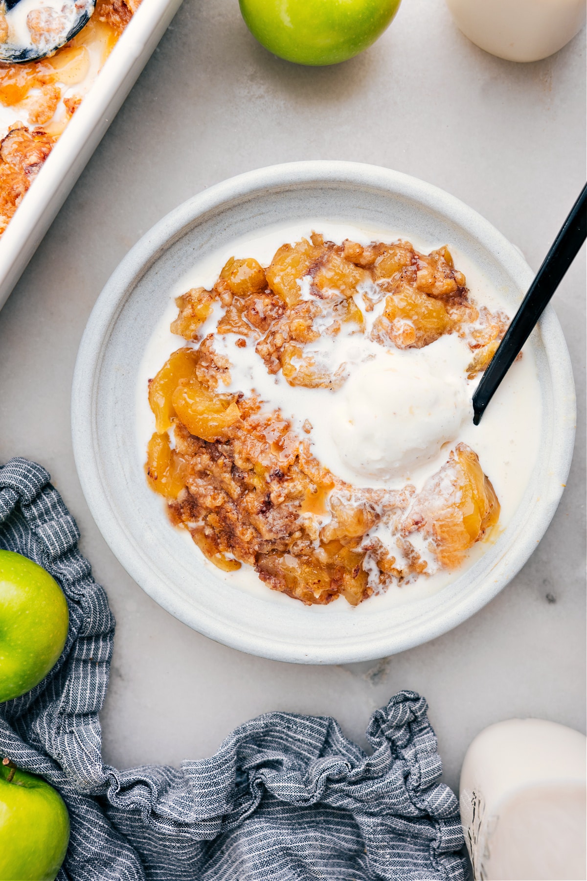 Apple Dump Cake on a plate with ice cream.