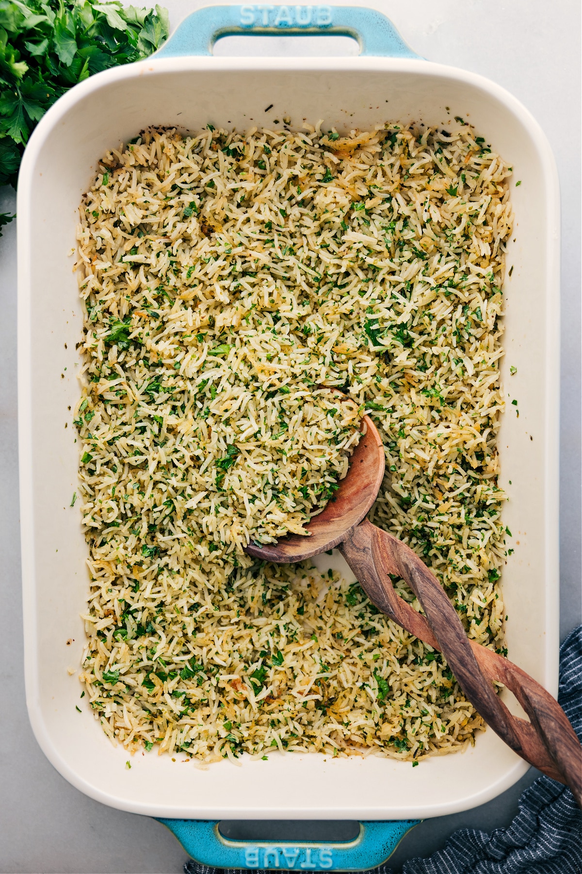 Herb Rice cooked in a single casserole dish, with a big scoop served up.