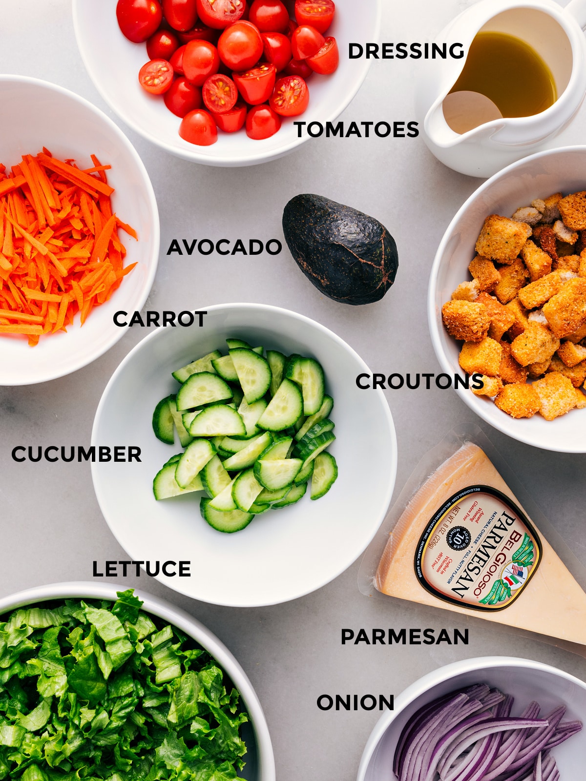 Prep the avocado, lettuce, Parmesan, croutons, cucumbers, tomatoes, and dressing for easy assembly.