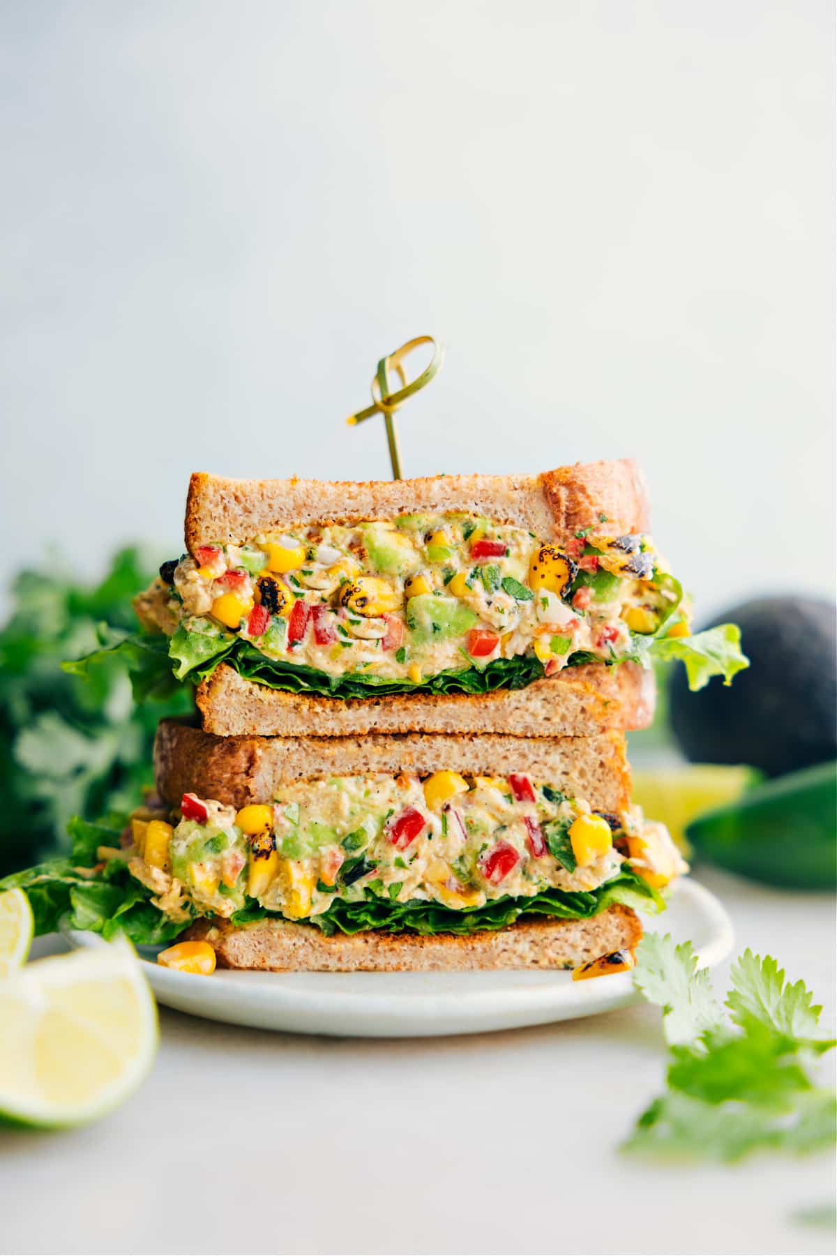 Mexican Street Corn Chicken Salad sandwiched between bread and lettuce.