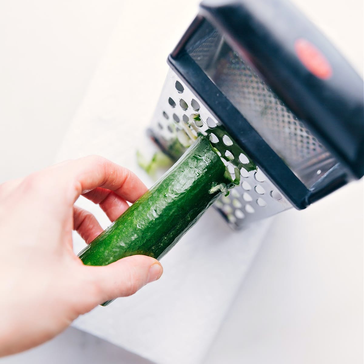 Grating cucumber for tzatziki sauce.