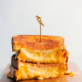 Grilled Cheese stacked on top of each other showing the cheesy center.