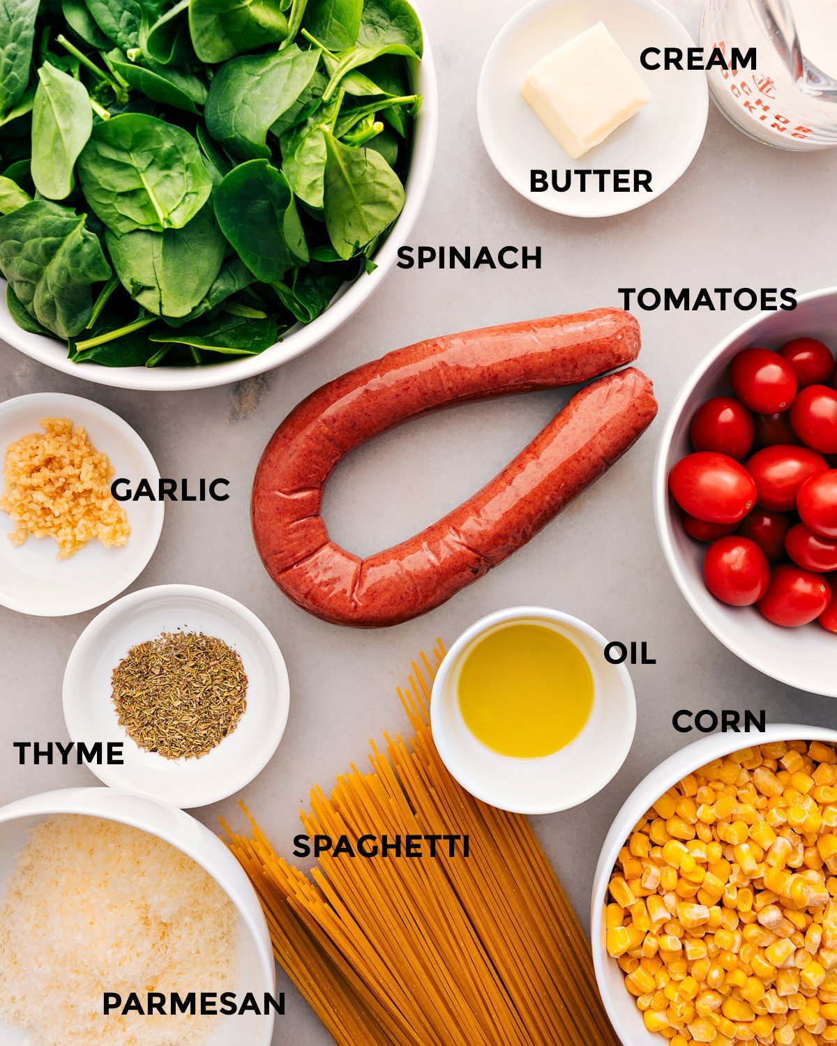 Ingredients prepped for easy assembly: veggies, meat, spaghetti, seasonings, oil, and parmesan.