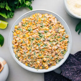 Mexican Street Corn Dip in a bowl with chips ready to be enjoyed.