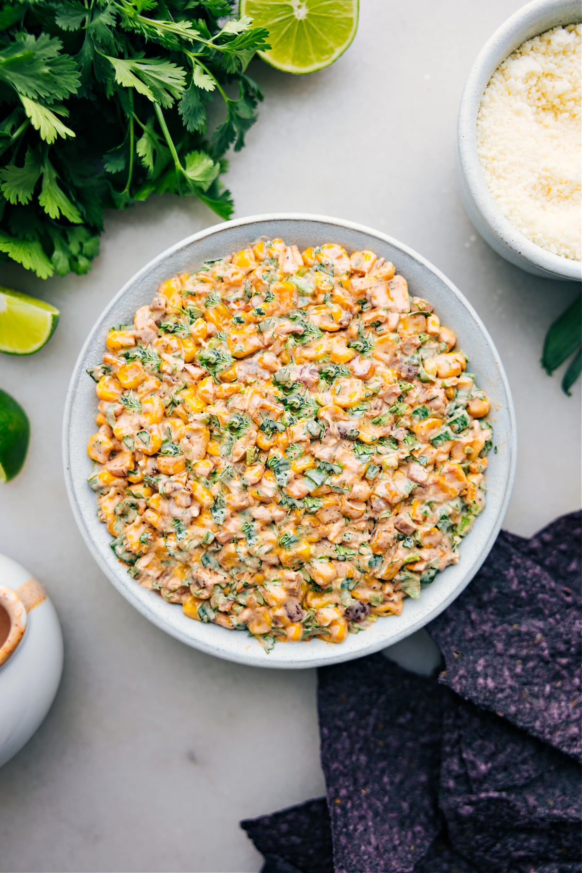 Mexican Street Corn Dip in a bowl with chips ready to be enjoyed.