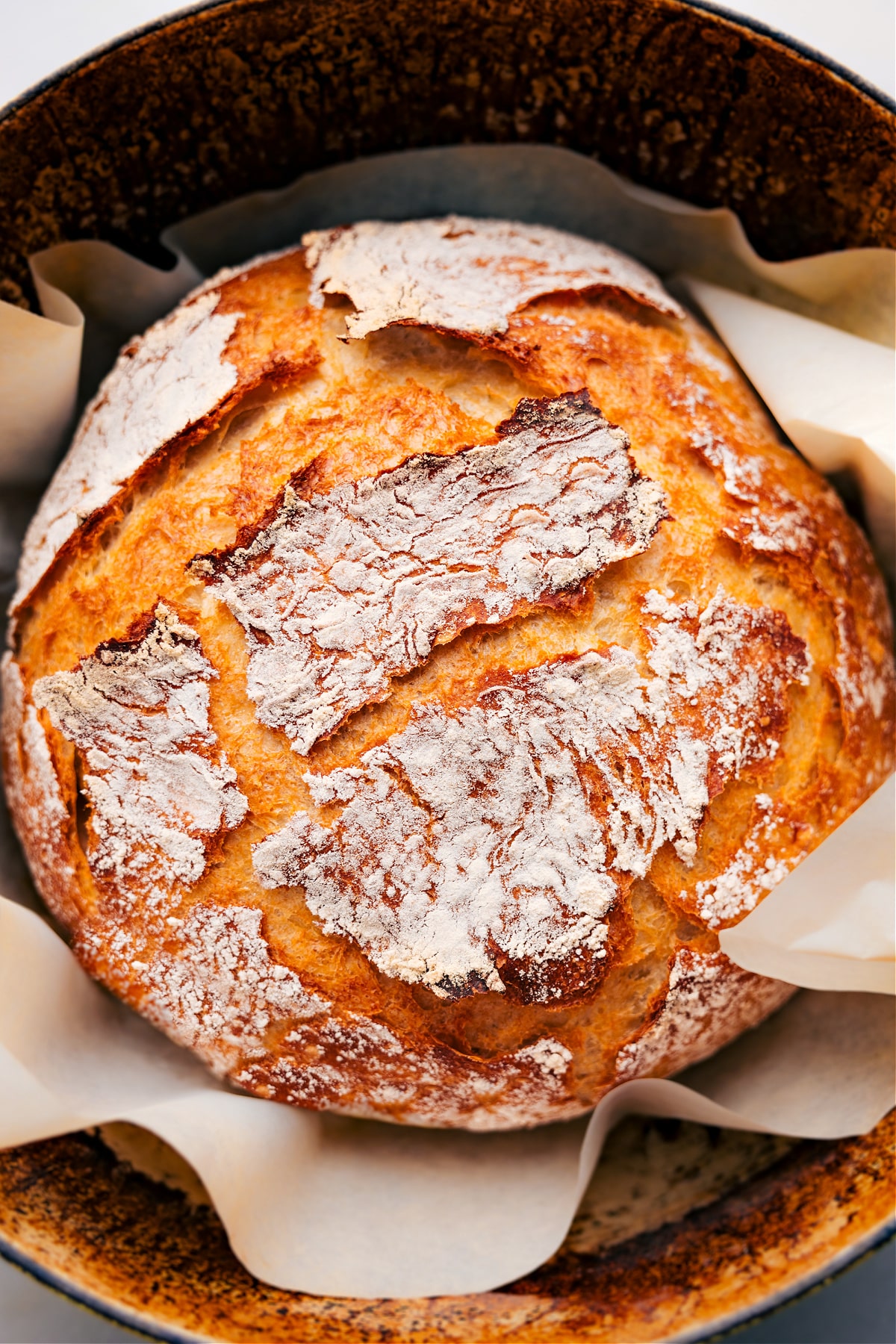 Freshly baked No-Knead Bread is out of the pot, ready to slice and enjoy.